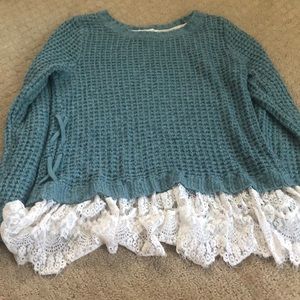 Turquoise sweater with lace and crisscross detail
